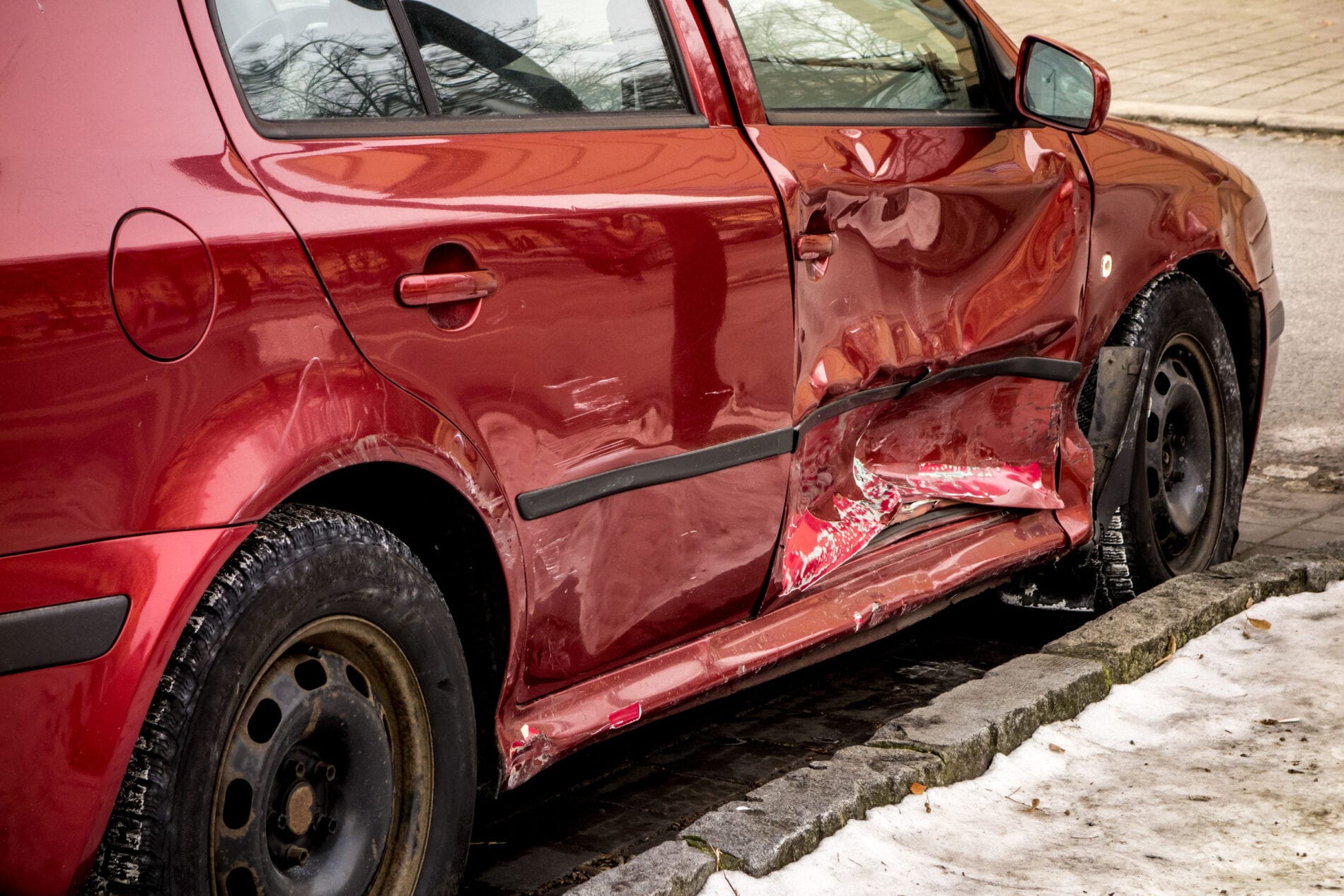 wine red damaged car with dents